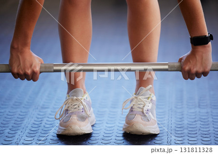 Barbell, hands and woman exercise on floor for fitness, workout and sports challenge in gym. Closeup female athlete, bodybuilder and heavy weights on ground for deadlift, wellness and muscle power 131811328
