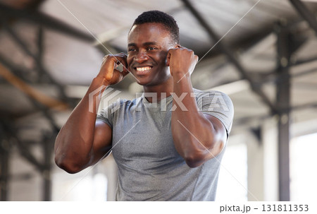 Music, exercise and man at gym with earphones while training, cardio and fitness on mockup background. Radio, workout and black guy listening to podcast, track or audio at sports center for routine 131811353