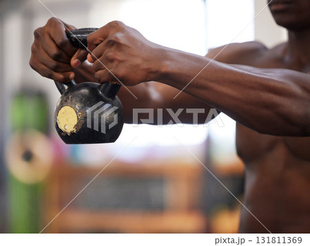 Kettlebell in black man hands, fitness in gym and weightlifting for strong arm muscle and bodybuilder training. Exercise for biceps, bodybuilding and strength with health and wellness of athlete Kettlebell in black man hands, fitness in gym and weightlifting for strong arm muscle and bodybuilder training. Exercise for biceps, bodybuilding and strength with health and wellness of athlete 131811369