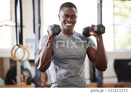 Fitness, weights and portrait of a black man lifting for muscle, training and power in the gym. Smile, strong and African athlete doing a workout, exercise or sports for body building and cardio Fitness, weights and portrait of a black man lifting for muscle, training and power in the gym. Smile, strong and African athlete doing a workout, exercise or sports for body building and cardio 131811373