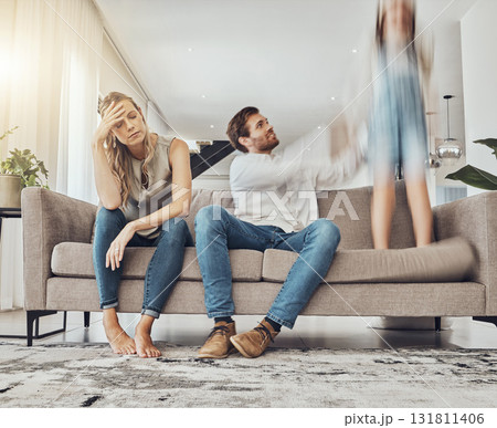 Family life stress, parents and child, chaos at home and energy, motion blur and burnout headache. Kid jump on couch, woman has migraine and man calming girl, hyperactive with ADHD and mental health Family life stress, parents and child, chaos at home and energy, motion blur and burnout headache. Kid jump on couch, woman has migraine and man calming girl, hyperactive with ADHD and mental health 131811406