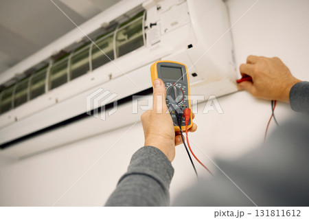 Air conditioner, maintenance hands and voltage meter with construction, wall and technician man. AC repair, professional hvac expert and handyman with digital reading, analysis or engineering service Air conditioner, maintenance hands and voltage meter with construction, wall and technician man. AC repair, professional hvac expert and handyman with digital reading, analysis or engineering service 131811612
