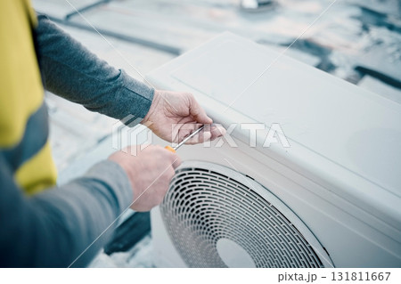 Hands, air conditioner and maintenance with a man construction worker on a rooftop to install a cooling system. Engineer, hvac and ac repair with a male handyman servicing a building closeup 131811667