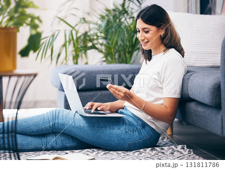 Credit card, online shopping and woman on laptop, banking and fintech for easy payment on home carpet. Young person or student with computer for e commerce sale, finance and wealth in her living room Credit card, online shopping and woman on laptop, banking and fintech for easy payment on home carpet. Young person or student with computer for e commerce sale, finance and wealth in her living room 131811786