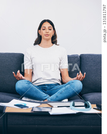 Zen, meditation and Indian woman in a living room with yoga to relax from book learning. Sofa, home and female student meditate on a couch doing wellness exercise in a house with education notebook 131811797