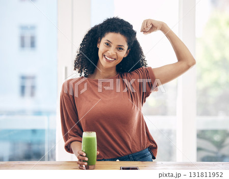 Portrait, muscle and smoothie with a black woman in the kitchen of a home flexing her bicep for health. Wellness, weight loss and strong with an attractive young female drinking a diet beverage Portrait, muscle and smoothie with a black woman in the kitchen of a home flexing her bicep for health. Wellness, weight loss and strong with an attractive young female drinking a diet beverage 131811952