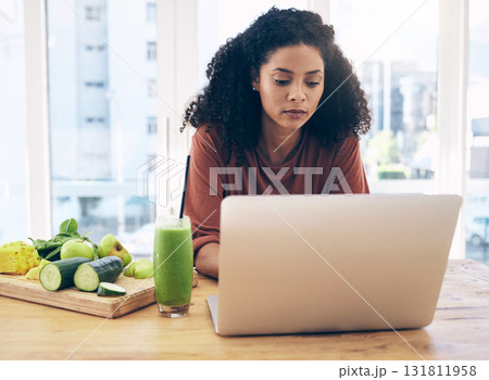 Relax, smoothie and health with black woman and laptop for blog research, salad and vegetables. Nutritionist, diet and food with girl by kitchen counter for cooking, technology and learning at home Relax, smoothie and health with black woman and laptop for blog research, salad and vegetables. Nutritionist, diet and food with girl by kitchen counter for cooking, technology and learning at home 131811958
