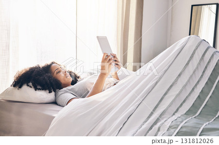 Relax, black woman and tablet in bed in bedroom for social media, texting or internet browsing in the morning. Technology, home and female with digital touchscreen for web scrolling after waking up. Relax, black woman and tablet in bed in bedroom for social media, texting or internet browsing in the morning. Technology, home and female with digital touchscreen for web scrolling after waking up. 131812026