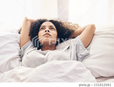 Black woman, morning and thinking in home bedroom after sleeping or resting. Peace, bed relax and comfort of young female lost in thoughts, focus or contemplating ideas after waking up in house alone 131812081