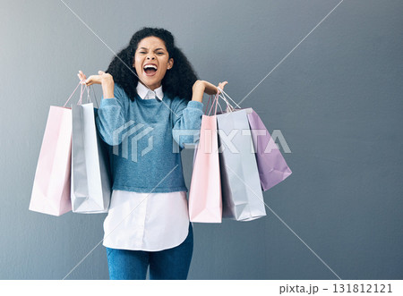 Shopping, black woman excited and scream portrait of a happy customer with bags after shop sale. Isolated, gray background and female smile in a studio holding a bag with discount market product 131812121