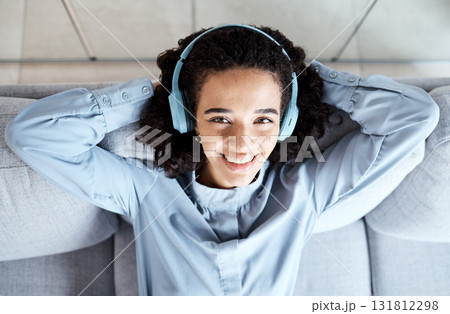 Top view, portrait and woman on sofa, headphones and relax for break, peace and smile with joy. Female, lady and headset music, streaming and listen to podcast for happiness, cheerful and peaceful Top view, portrait and woman on sofa, headphones and relax for break, peace and smile with joy. Female, lady and headset music, streaming and listen to podcast for happiness, cheerful and peaceful 131812298