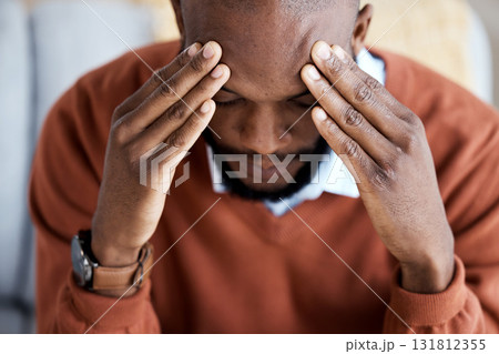 Headache, stress and sad with black man on sofa for burnout, mental health and anxiety. Depression, thinking and frustrated with guy in living room suffering with problem, worried and exhausted 131812355