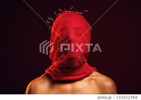 Red fabric, creative aesthetic and religion in a studio with a face covering model for luxury clothing. Glamour, religious crown of thorns and a woman with god respect wearing vintage or silk apparel Red fabric, creative aesthetic and religion in a studio with a face covering model for luxury clothing. Glamour, religious crown of thorns and a woman with god respect wearing vintage or silk apparel 131812368