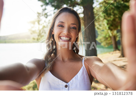 Nature, happy and woman taking a selfie in the forest while on outdoor adventure alone on a weekend trip. Happiness, smile and portrait of female taking picture in woods on travel holiday or vacation Nature, happy and woman taking a selfie in the forest while on outdoor adventure alone on a weekend trip. Happiness, smile and portrait of female taking picture in woods on travel holiday or vacation 131812378