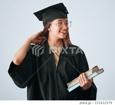 Graduation cap, books and woman isolated on studio background for happy education, college or scholarship success. Biracial university student or graduate with reading knowledge and learning goals Graduation cap, books and woman isolated on studio background for happy education, college or scholarship success. Biracial university student or graduate with reading knowledge and learning goals 131812379