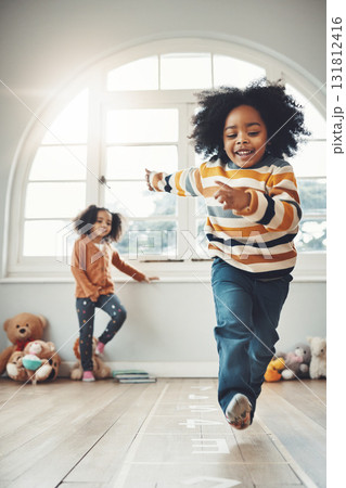 Hopscotch, happy and children play in home having fun, enjoy games and relax together in room. Childhood, entertainment and excited siblings in bedroom for jumping game, playing and activity Hopscotch, happy and children play in home having fun, enjoy games and relax together in room. Childhood, entertainment and excited siblings in bedroom for jumping game, playing and activity 131812416
