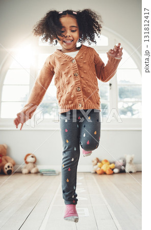 Hopscotch, happy and girl play in bedroom having fun, enjoying games and relax on weekend. Childhood, kindergarten and excited girl in bedroom for jumping game, playing and numbers activity on floor Hopscotch, happy and girl play in bedroom having fun, enjoying games and relax on weekend. Childhood, kindergarten and excited girl in bedroom for jumping game, playing and numbers activity on floor 131812417