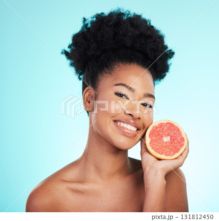 Grapefruit, skincare smile and woman portrait of beauty, wellness and detox healthcare. Isolated, blue background and studio with a female feeling happy from healthy fruit with vitamin c for glow 131812450