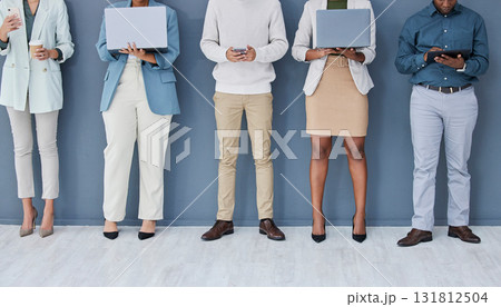 Business people, waiting or technology in job interview row, recruitment line or hr wall queue. Diversity, men or women legs in human resources, hiring or onboarding office on phone, laptop or tablet 131812504