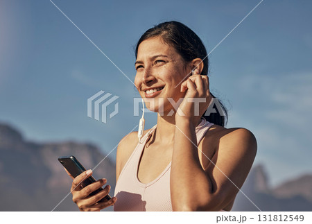 Woman, fitness and phone for music in nature outdoor for exercise, training and workout. Happy model person listening to earphones for podcast, audio and motivation for health and wellness blue sky Woman, fitness and phone for music in nature outdoor for exercise, training and workout. Happy model person listening to earphones for podcast, audio and motivation for health and wellness blue sky 131812549