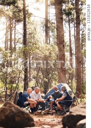 Man, people and camping in nature for travel, adventure or summer vacation together with chairs and tent in forest. Group of men relaxing and talking enjoying camp out by tall green trees in outdoors 131812616