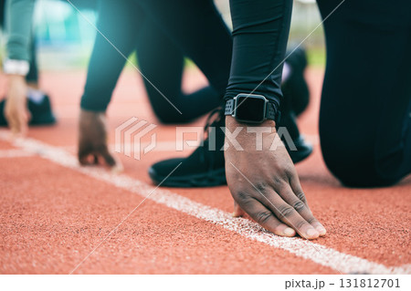 Athlete, runner and fitness person at start of a race on a sports track for exercise, workout or motivation. Running, sprint and closeup of man ready for training as wellness, competition and health 131812701
