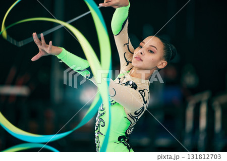 Sports, gymnastics and female performing with a ribbon for a competition or training in sport arena. Fitness, athlete and woman practicing for balance, endurance and flexibility exercise for routine. 131812703