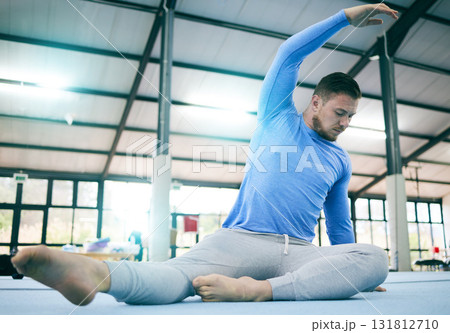 Sports, gymnastics and man stretching body ready to start warm up for training, exercise and workout on floor. Fitness, motivation and male athlete with focus for balance, performance and competition 131812710