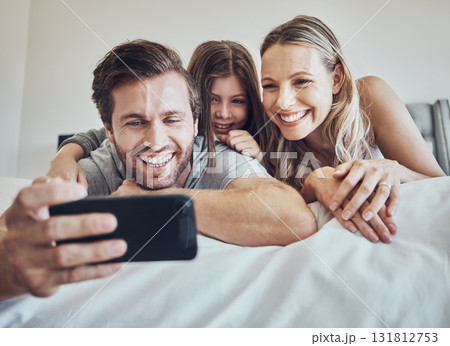 Portrait, relax or parents take a selfie with a girl as a happy family in house bedroom bonding in Berlin. Mother, father or child relaxing together enjoying quality time or taking pictures at home Portrait, relax or parents take a selfie with a girl as a happy family in house bedroom bonding in Berlin. Mother, father or child relaxing together enjoying quality time or taking pictures at home 131812753
