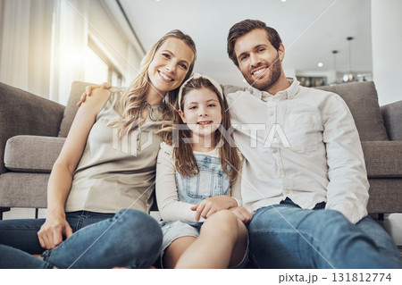 Portrait, mother or father with a kid to relax as a happy family in living room bonding in Australia with love or care. Hugging, trust or parent smile with girl enjoying quality time on a fun holiday Portrait, mother or father with a kid to relax as a happy family in living room bonding in Australia with love or care. Hugging, trust or parent smile with girl enjoying quality time on a fun holiday 131812774