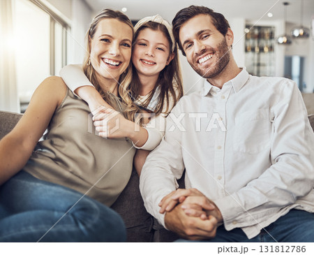 Portrait, mother or father with a girl to relax as a happy family in living room bonding in Australia with love or care. Hugging, sofa or parents smile with kid enjoying quality time on a fun holiday 131812786