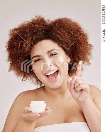 Skincare, portrait of black woman and cream on finger, smile and afro, advertising luxury product. Dermatology, cosmetic and facial beauty for happy model isolated on studio background, lotion in jar 131812952