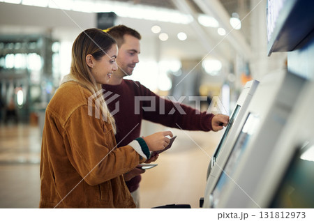 Travel, airport and couple at check in machine with passport and ticket for flight. Valentines day, immigration or happy man and woman by airline lobby or kiosk for boarding pass for holiday vacation 131812973