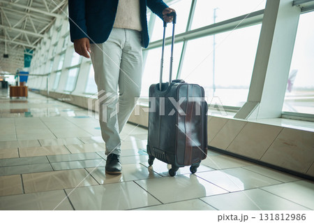 Airport legs, travel and man walking to airplane, flight booking or transportation for corporate trip. Luggage suitcase, plane departure or African businessman on holiday, vacation or global journey Airport legs, travel and man walking to airplane, flight booking or transportation for corporate trip. Luggage suitcase, plane departure or African businessman on holiday, vacation or global journey 131812986