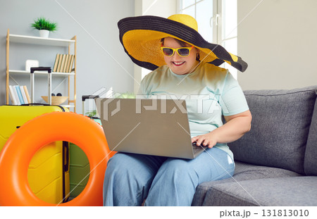 Happy overweight tourists woman booking hotel online using laptop Happy overweight tourists woman booking hotel online using laptop 131813010
