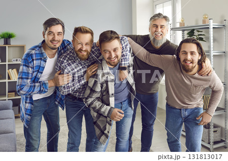 Male bearded friends looking cheerful at camera and smiling having fun at home. 131813017