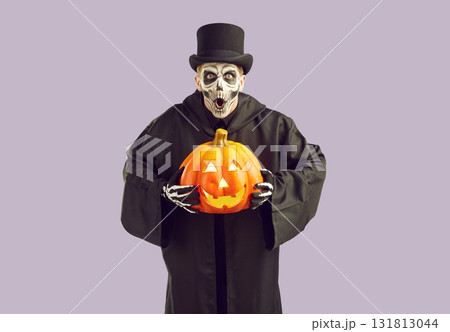 Frightening crazy man in masquerade costume frightfully exclaims frighteningly on Halloween. Frightening crazy man in masquerade costume frightfully exclaims frighteningly on Halloween. 131813044