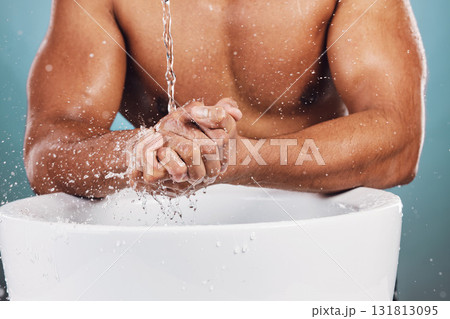 Man, water splash and hands by basin for skincare, hygiene or wash against studio background. Hand of young male model in beauty, wellness and washing or cleansing for body care and self love by sink Man, water splash and hands by basin for skincare, hygiene or wash against studio background. Hand of young male model in beauty, wellness and washing or cleansing for body care and self love by sink 131813095