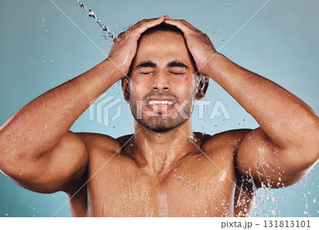 Man, water splash and face wash for skincare hygiene, hydration or shower against studio background. Young male model in beauty, wellness and washing or cleansing for clean facial body care treatment 131813101