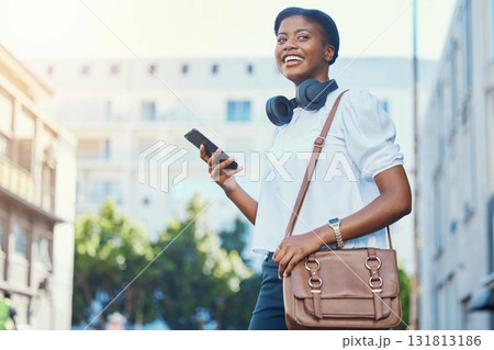 Phone, walking and young woman in the city networking on social media, mobile app or the internet. Happy, technology and African female person scroll on cellphone and commuting in urban town street. Phone, walking and young woman in the city networking on social media, mobile app or the internet. Happy, technology and African female person scroll on cellphone and commuting in urban town street. 131813186