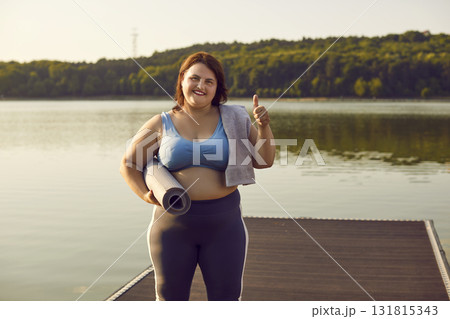 Fat woman in sportswear showing thumb up sign celebrating success in workout outdoors Fat woman in sportswear showing thumb up sign celebrating success in workout outdoors 131815343