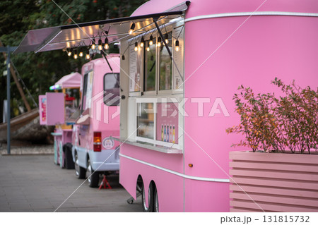 Pink ice cream vans on street in city, mobile fair trade with food trucks. Pink ice cream vans on street in city, mobile fair trade with food trucks. 131815732