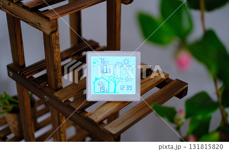 A digital weather station and thermometer displayed in a cozy home environment A digital weather station and thermometer displayed in a cozy home environment 131815820