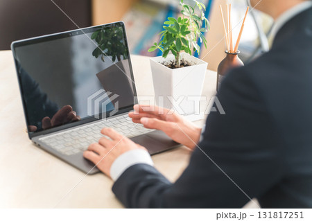 ノートパソコンでタイピングするスーツの男性の手元 131817251