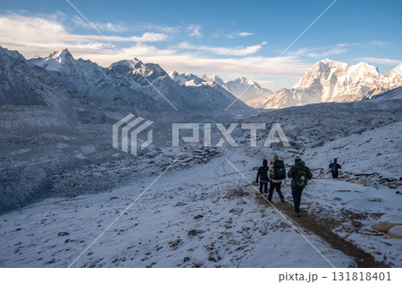 Tourist walking to Gorakshep village the last village before reaching to Everest Base Camp in Nepal during sunrise. Tourist walking to Gorakshep village the last village before reaching to Everest Base Camp in Nepal during sunrise. 131818401