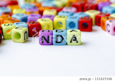 NDA text on multicolored cubes representing Non Disclosure Agreement . Conservation concept. 131825586