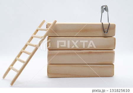 A figure pin on top of wooden blocks with customizable space for text or ideas. A figure pin on top of wooden blocks with customizable space for text or ideas. 131825610