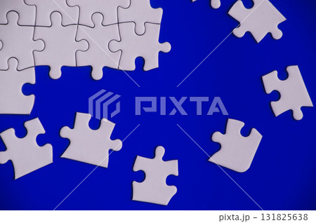 Broken pieces of jigsaw puzzles on blue background. Broken pieces of jigsaw puzzles on blue background. 131825638