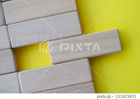 Top view of wooden blocks on yellow cover with customizable space for text. Top view of wooden blocks on yellow cover with customizable space for text. 131825655