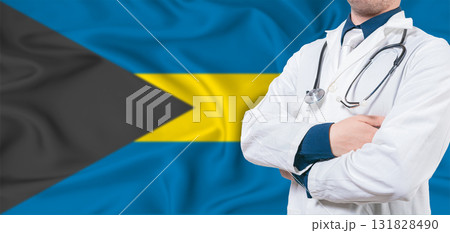 Bahamas healthcare concept. Male doctor on Bahamas flag. Doctor with crossed arms on Bahamas flag 131828490